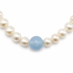 Close-up of the translucent 8mm blue aquamarine bead between 5.5mm freshwater pearls