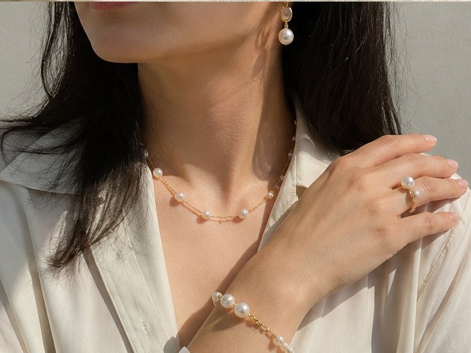 Woman wearing cultured freshwater pearl jewelry in natural daylight